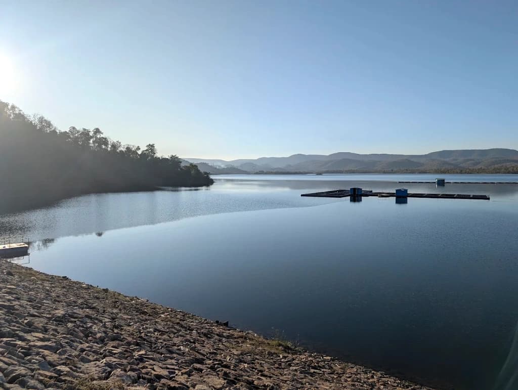 Scenic freshwater expanse of Chhirpani Dam reservoir backed by green Maikal hills in Kabirdham