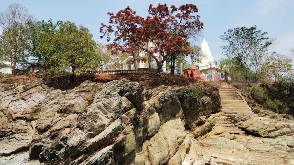 Ghoghra Waterfall cascading over rock ledges near the hilltop Shiva temple in Pandariya, Kabirdham