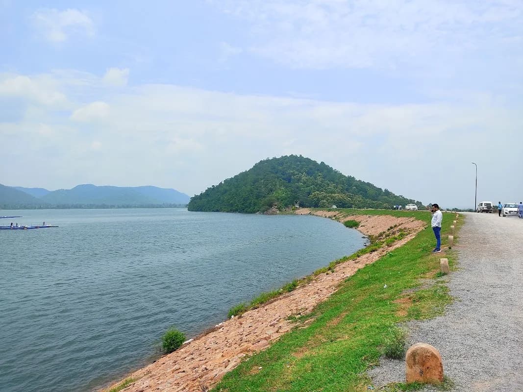 Calm water expanse and distant hills of Sarodha Dam during sunset Kawardha