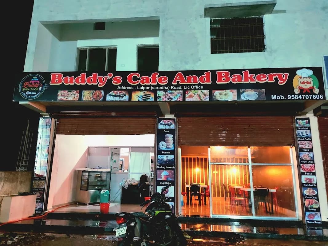 Modern cozy cafe interior with coffee counter and fresh bakes at Buddys Cafe Kawardha