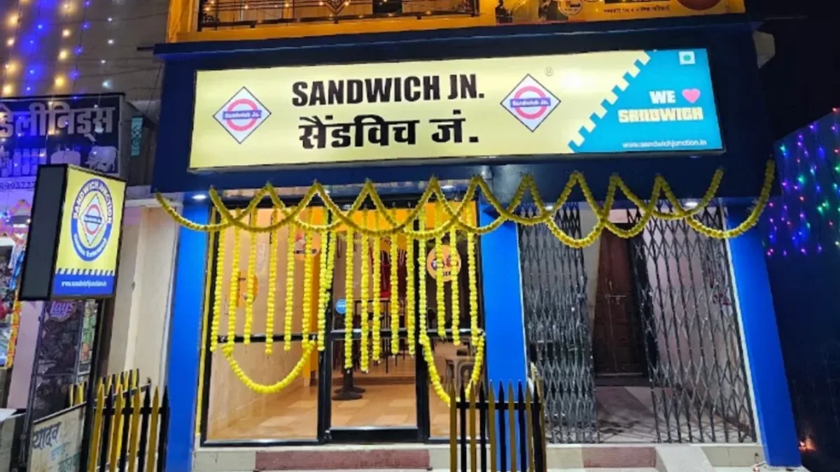 Illuminated storefront of Sandwich Jn. cafe on Gayatri Mandir Road Kawardha